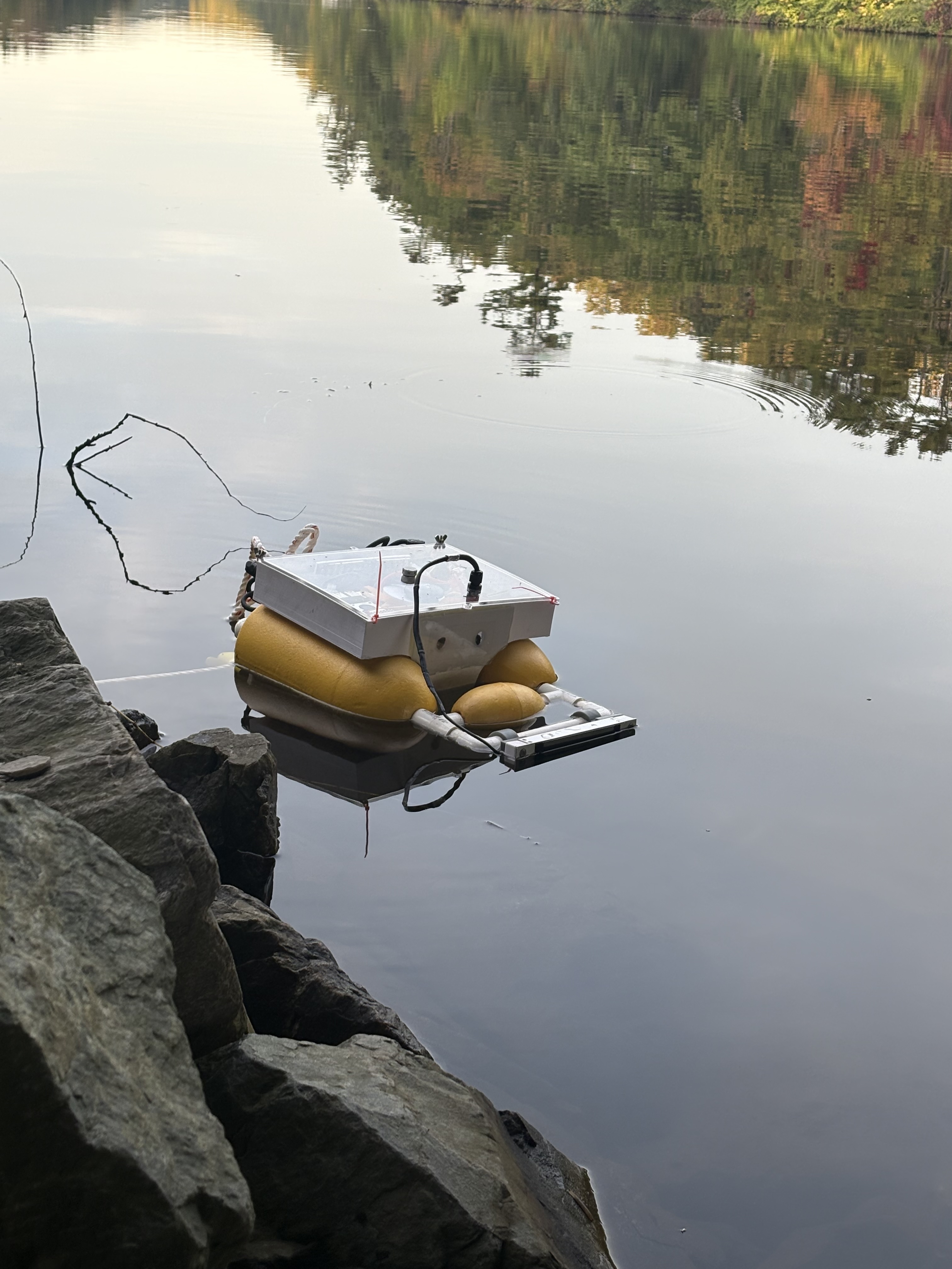 Daughter boat floating beside a rocky shoreline